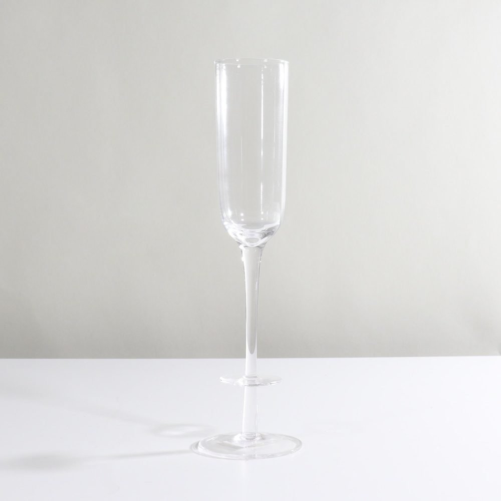 clear glass champagne flute with disc accent on stem